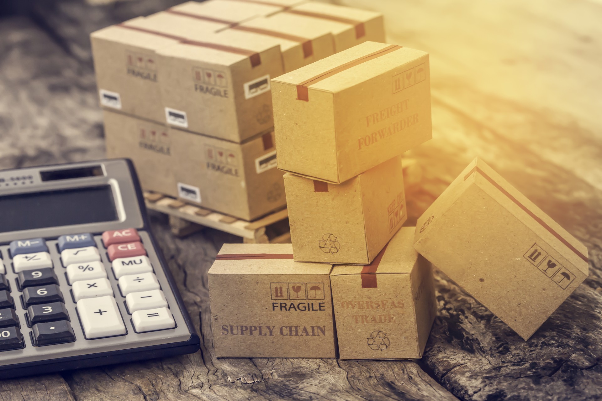 business concept: Cardboard boxes and calculator. Concept of Increasing product rates the expansion of export business to plan marketing or finance go future.